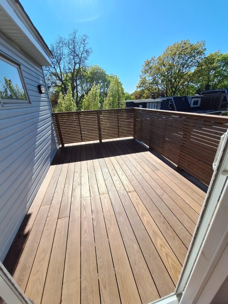Wood deck with horizontal privacy fencing beside a Toronto home