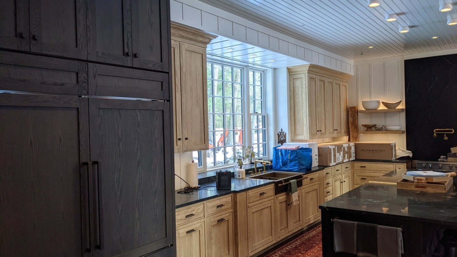 Wood kitchen cabinetry and trim in a cottage interior